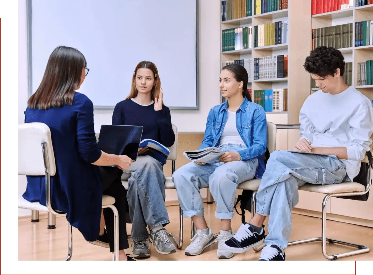 A group of people sitting in chairs with books.